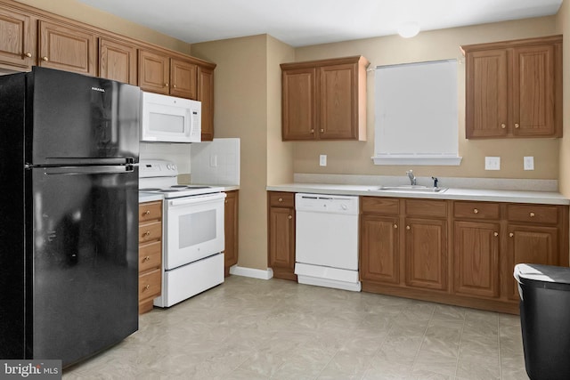 kitchen featuring white appliances and sink