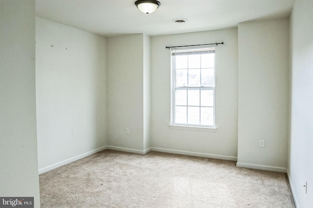 unfurnished room featuring light carpet