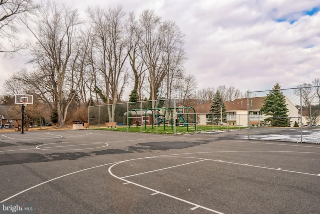 view of basketball court with a playground