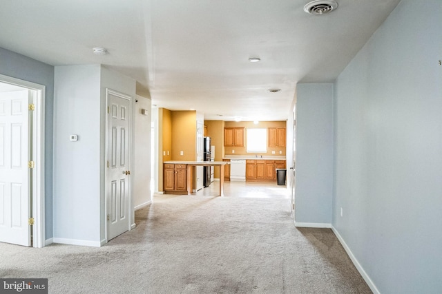 unfurnished living room featuring light carpet