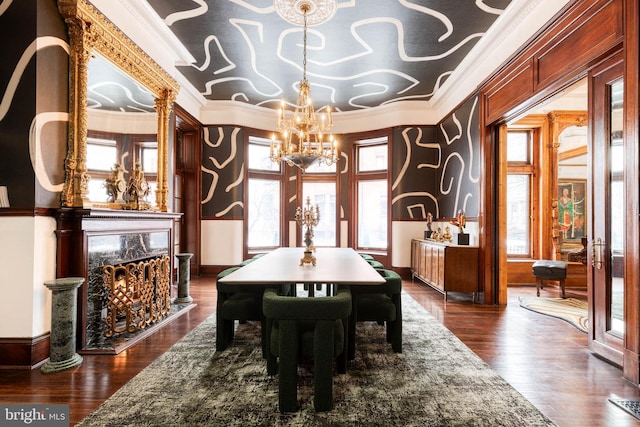 dining area featuring ornamental molding, a premium fireplace, dark wood-type flooring, an inviting chandelier, and french doors