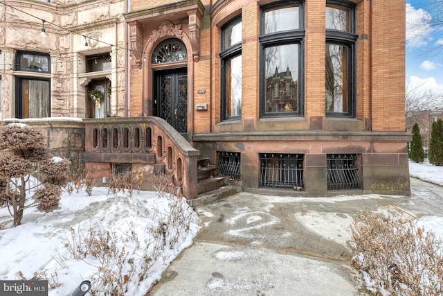 view of snow covered property entrance