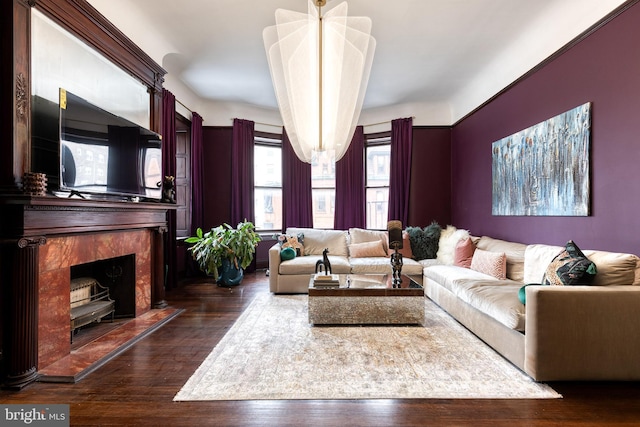 living room featuring dark wood-type flooring and a tile fireplace