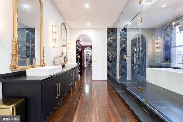 bathroom featuring vanity, a shower with door, and hardwood / wood-style floors