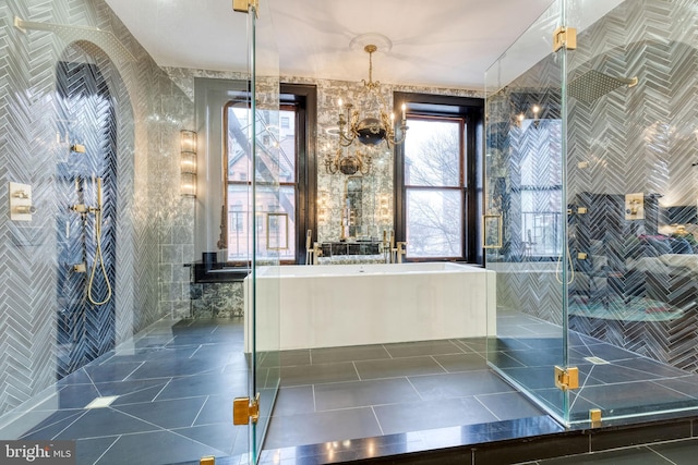 bathroom with independent shower and bath, a notable chandelier, tile walls, and tile patterned floors