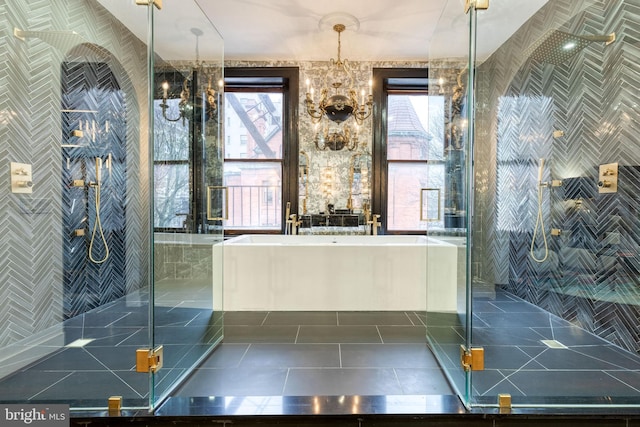 bathroom featuring separate shower and tub, tile patterned floors, and an inviting chandelier