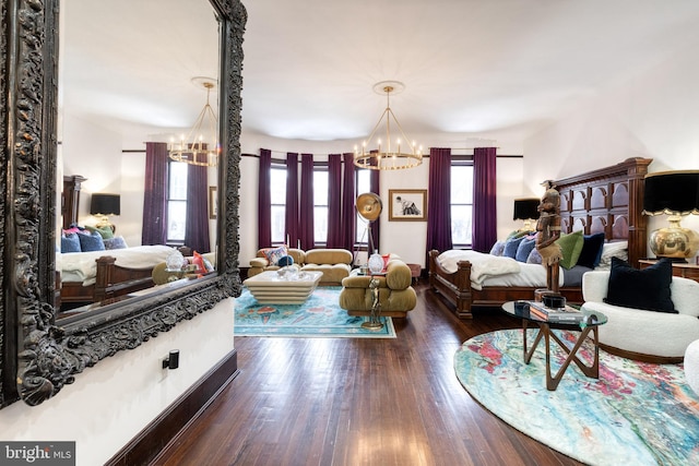 bedroom featuring dark hardwood / wood-style flooring and a chandelier