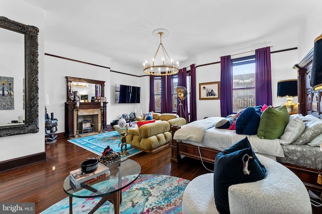 bedroom with a notable chandelier and dark wood-type flooring