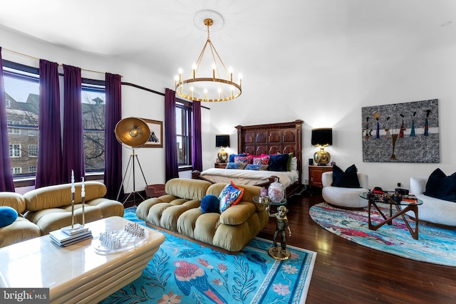 bedroom with a notable chandelier and dark hardwood / wood-style floors