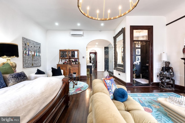 living room featuring dark hardwood / wood-style flooring and a wall unit AC