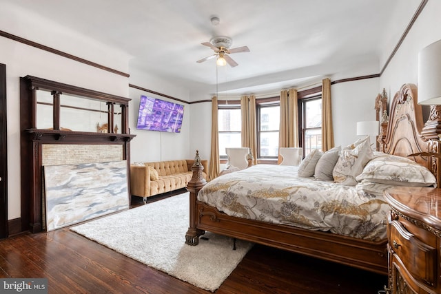 bedroom with dark hardwood / wood-style floors and ceiling fan