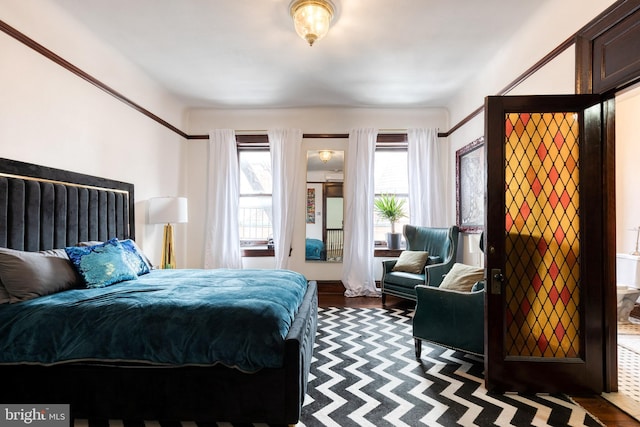 bedroom with dark hardwood / wood-style flooring