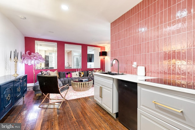 kitchen featuring white cabinetry, sink, black electric stovetop, and dark wood-type flooring