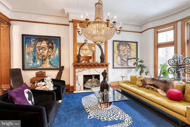 living room with an inviting chandelier, a high end fireplace, and ornamental molding