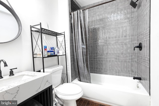 full bathroom featuring vanity, hardwood / wood-style floors, shower / tub combo with curtain, and toilet