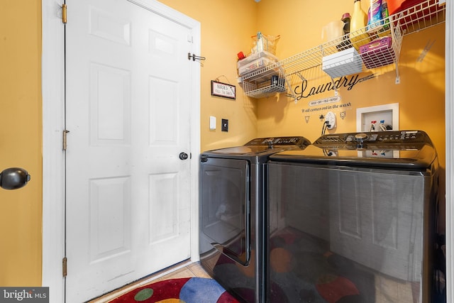 clothes washing area with washer and clothes dryer