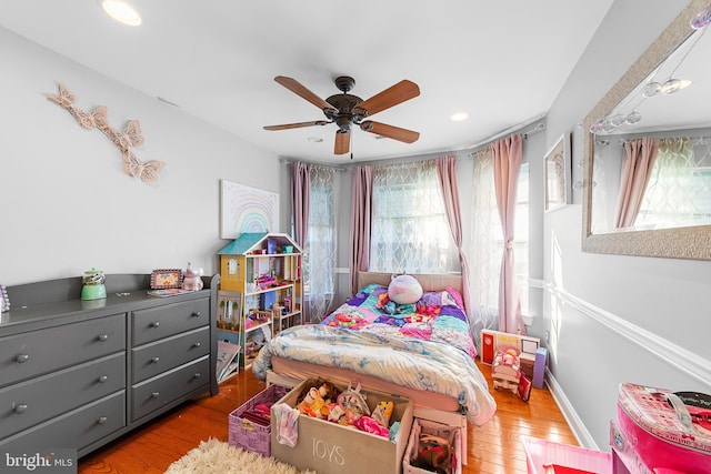 bedroom with light wood-type flooring and ceiling fan