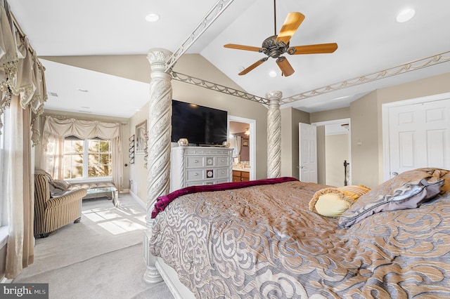 carpeted bedroom with connected bathroom, ceiling fan, and lofted ceiling