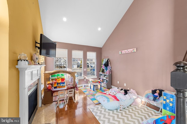 rec room featuring high vaulted ceiling and wood-type flooring