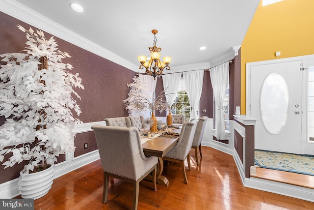 dining area featuring a chandelier, hardwood / wood-style floors, and ornamental molding