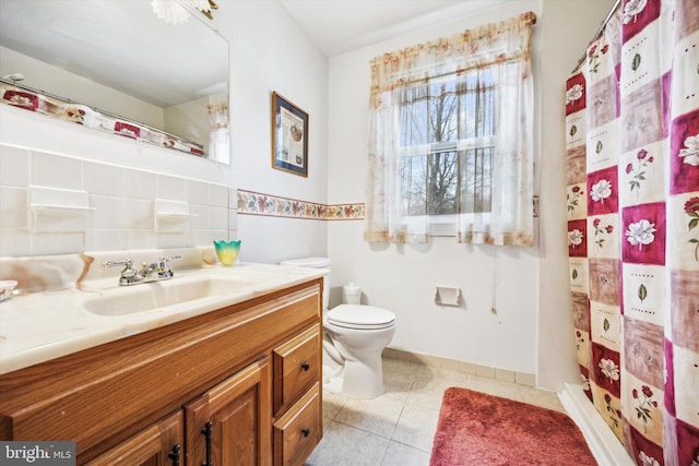 bathroom with tile patterned floors, a shower with curtain, vanity, and toilet