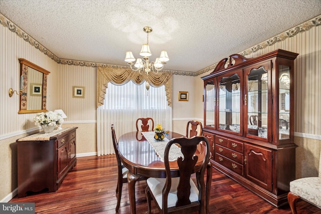 dining area with a textured ceiling, dark hardwood / wood-style floors, and a notable chandelier