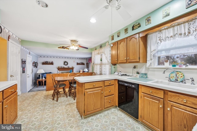 kitchen featuring sink, kitchen peninsula, black dishwasher, and a wealth of natural light