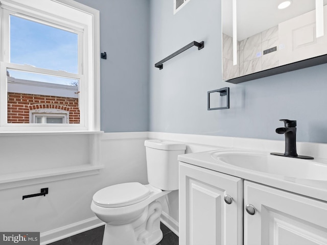 bathroom with vanity and toilet