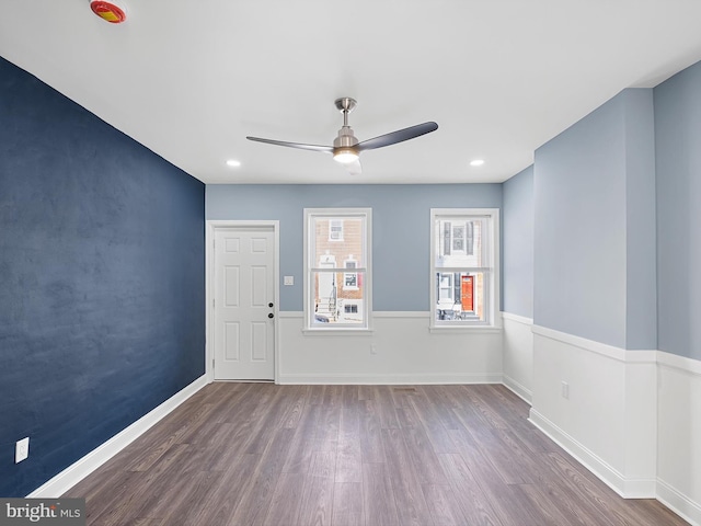 unfurnished room featuring ceiling fan and dark wood-type flooring