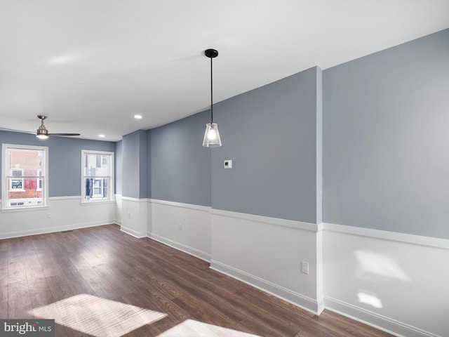 empty room with dark hardwood / wood-style floors and ceiling fan