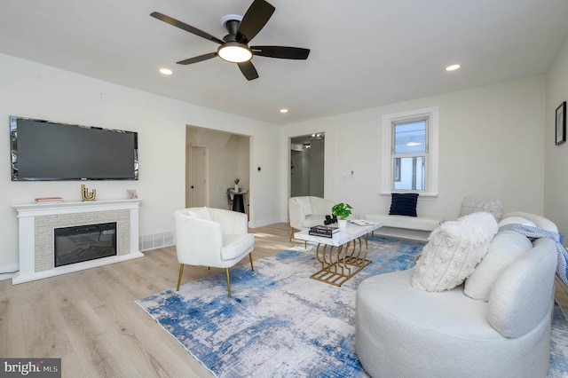 living room featuring ceiling fan and light wood-type flooring