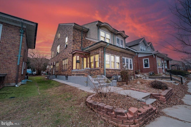 back house at dusk with a yard