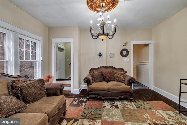 living room featuring a chandelier and dark hardwood / wood-style floors