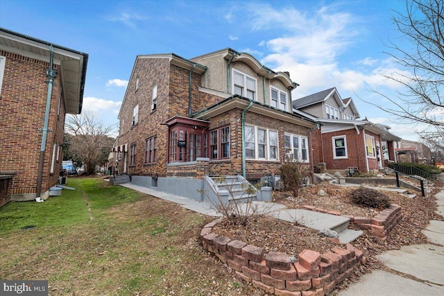 rear view of house featuring a lawn