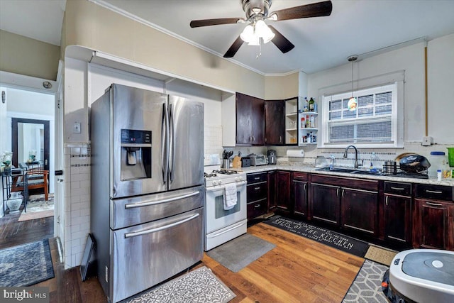 kitchen featuring sink, decorative light fixtures, dark hardwood / wood-style flooring, stainless steel fridge with ice dispenser, and white range with gas cooktop