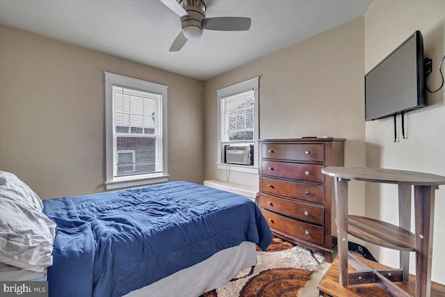 bedroom with ceiling fan and cooling unit