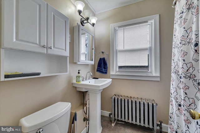 bathroom featuring toilet, radiator heating unit, sink, and an inviting chandelier