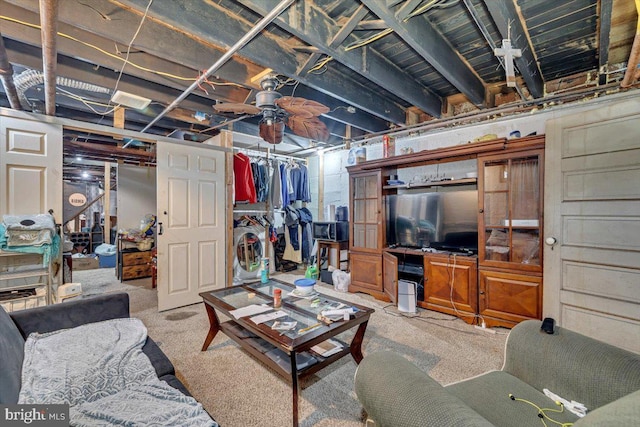 carpeted living room featuring washer and dryer and ceiling fan