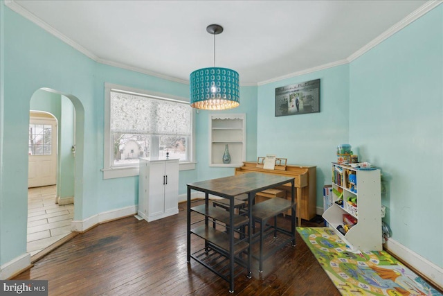 dining room featuring ornamental molding, dark hardwood / wood-style floors, and a healthy amount of sunlight