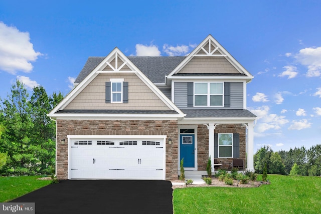 craftsman-style home featuring a front yard and a garage