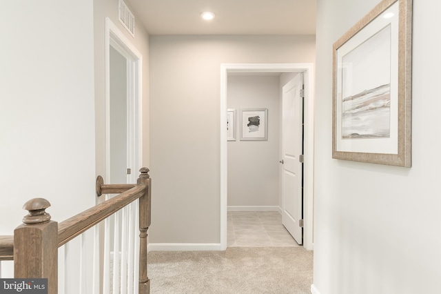 corridor featuring light carpet