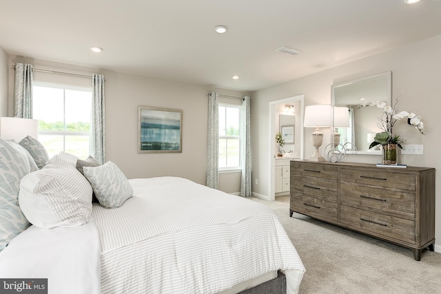 carpeted bedroom with ensuite bath