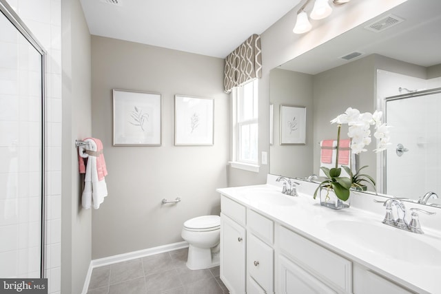 bathroom featuring an enclosed shower, vanity, toilet, and tile patterned flooring