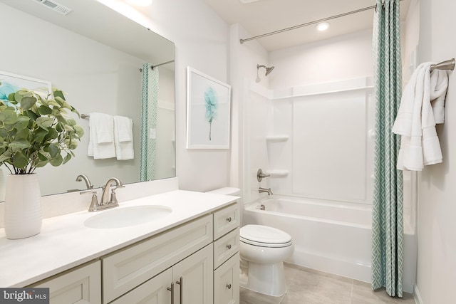 full bathroom featuring tile patterned flooring, shower / tub combo with curtain, vanity, and toilet