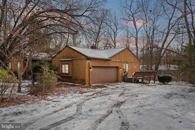 view of front of property featuring a deck and a garage