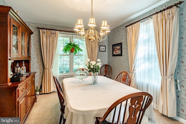 carpeted dining space with a chandelier