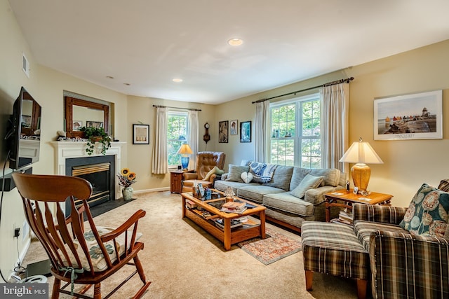 living room featuring plenty of natural light and light colored carpet