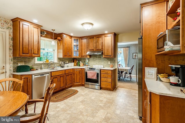 kitchen with pendant lighting, stainless steel appliances, and sink