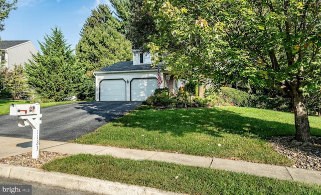 obstructed view of property featuring a front yard