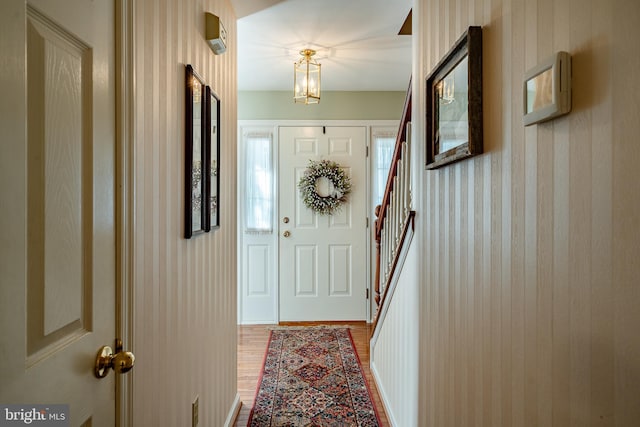 entryway featuring wood-type flooring and a chandelier